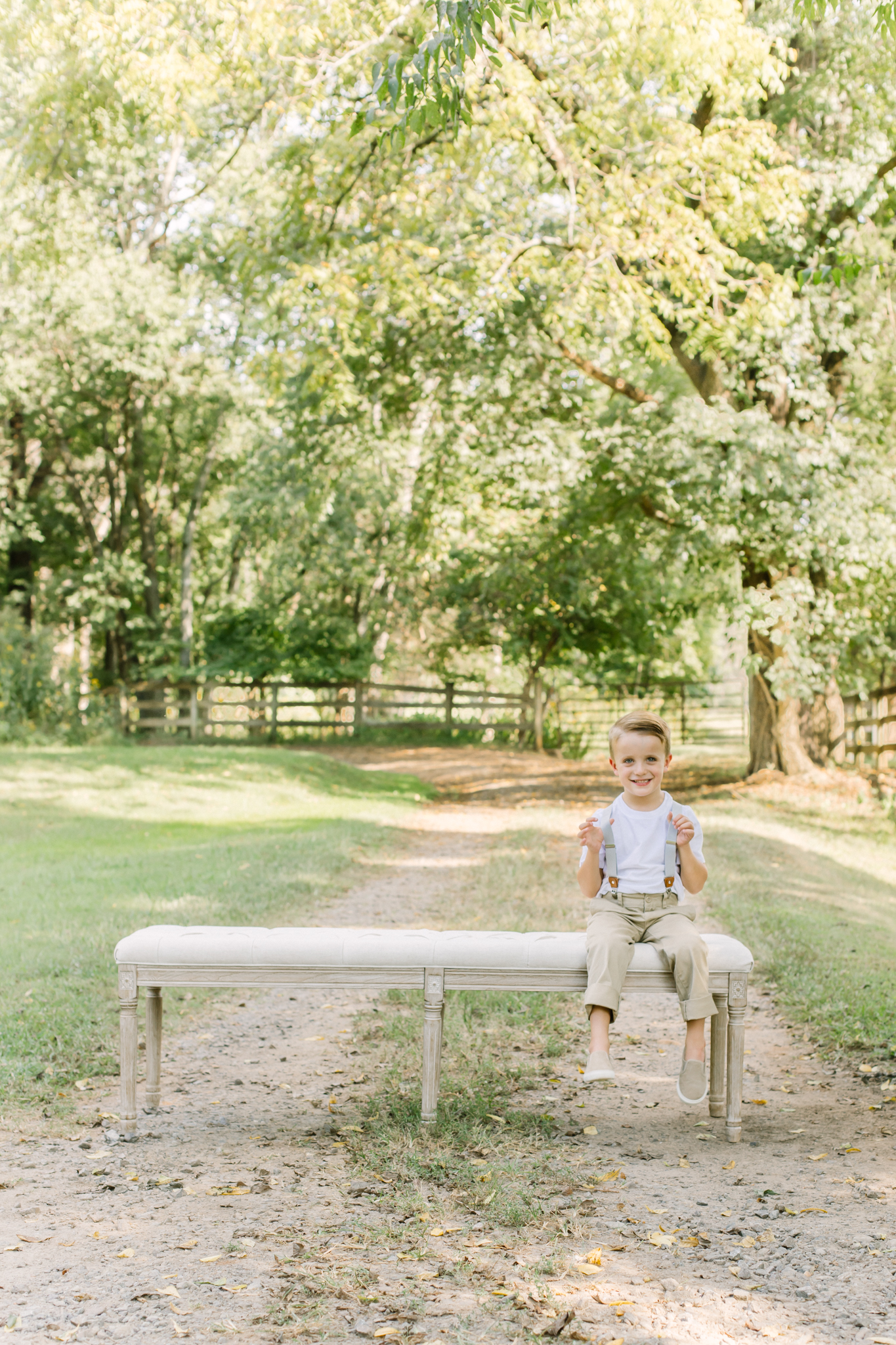 little boy sitting on bench