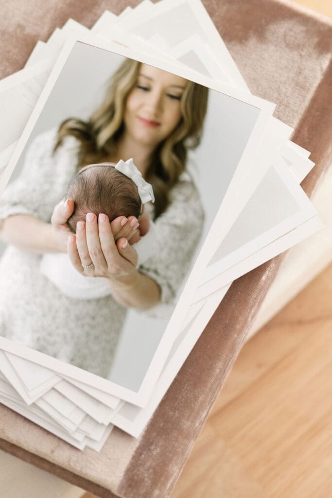 Stack of proof images on top of an album | Adrienne Elizabeth Photography