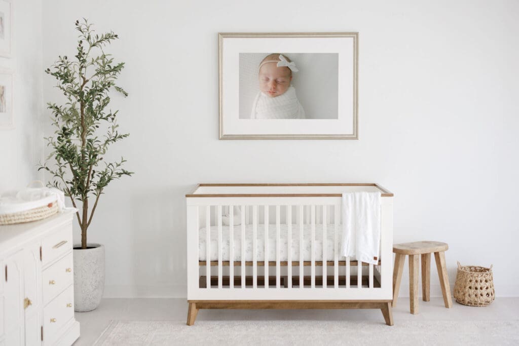 Wall art of a newborn hanging over the crib | Adrienne Elizabeth Photography