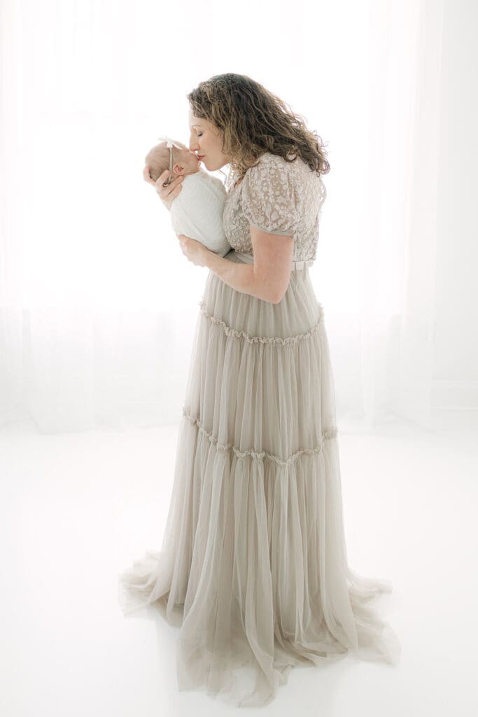 Mom holding her baby in studio | Adrienne Elizabeth Photography