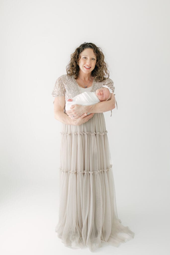 Mom holding her baby in studio | Adrienne Elizabeth Photography