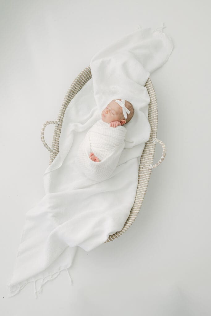 Newborn baby in moses basket | Adrienne Elizabeth Photography