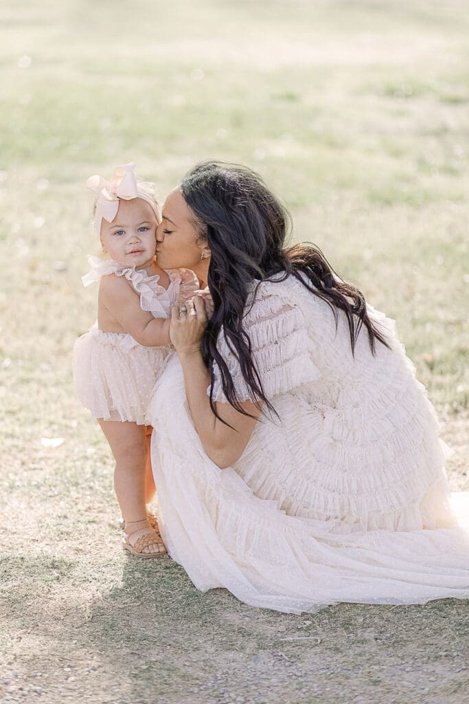 Mom kissing daughter on the cheek | Adrienne Elizabeth Photography